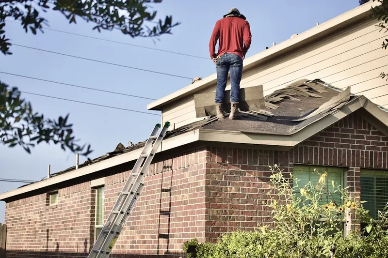 Professional roofer working on a residential roof in Whisper Walk